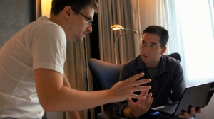 Edward Snowden (left) shows journalist Glenn Greenwald (right) how the encryption system works before sharing his leaked documents. Image via Spoilpolis.com.